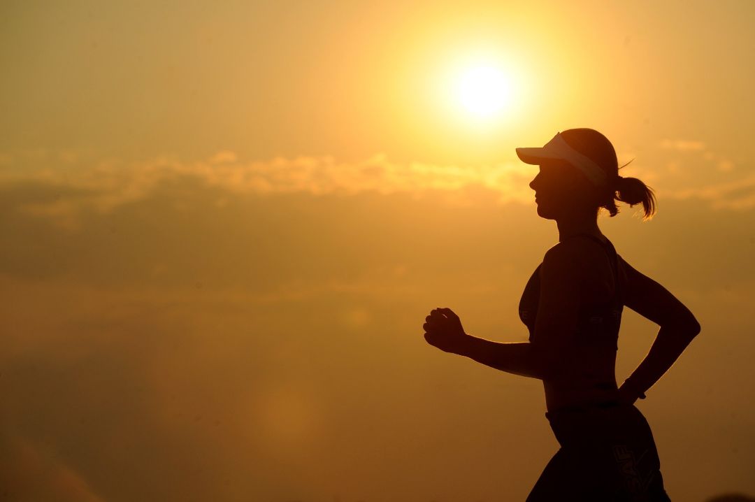 Silhouette of woman running, symbolizing she knows how to stay positive in the face of adversity. Silhouette of woman running, symbolizing she knows how to stay positive in the face of adversity.
