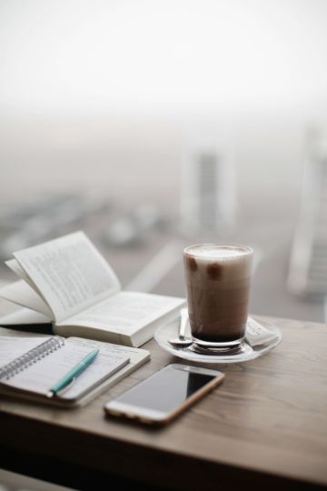 journal and coffee overlooking city, symbolizing you can do what you want with your life journal and coffee overlooking city, symbolizing you can do what you want with your life