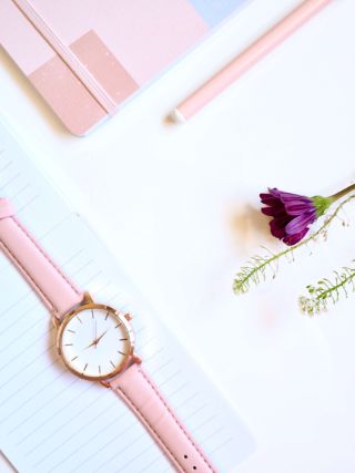pink watch and purple flower on white surface pink watch and purple flower on white surface, symbolizing you have time to do what you want with your life