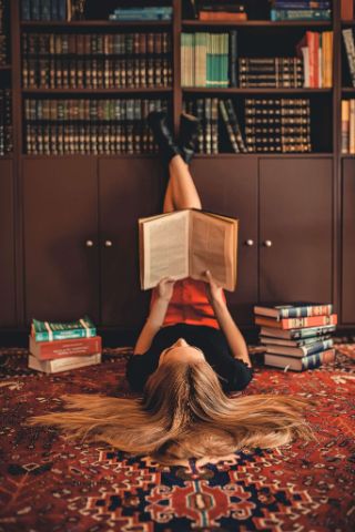 woman reading book in library as she thinks, "I don't know what to do with my life" woman reading book in library as she thinks, "I don't know what to do with my life"