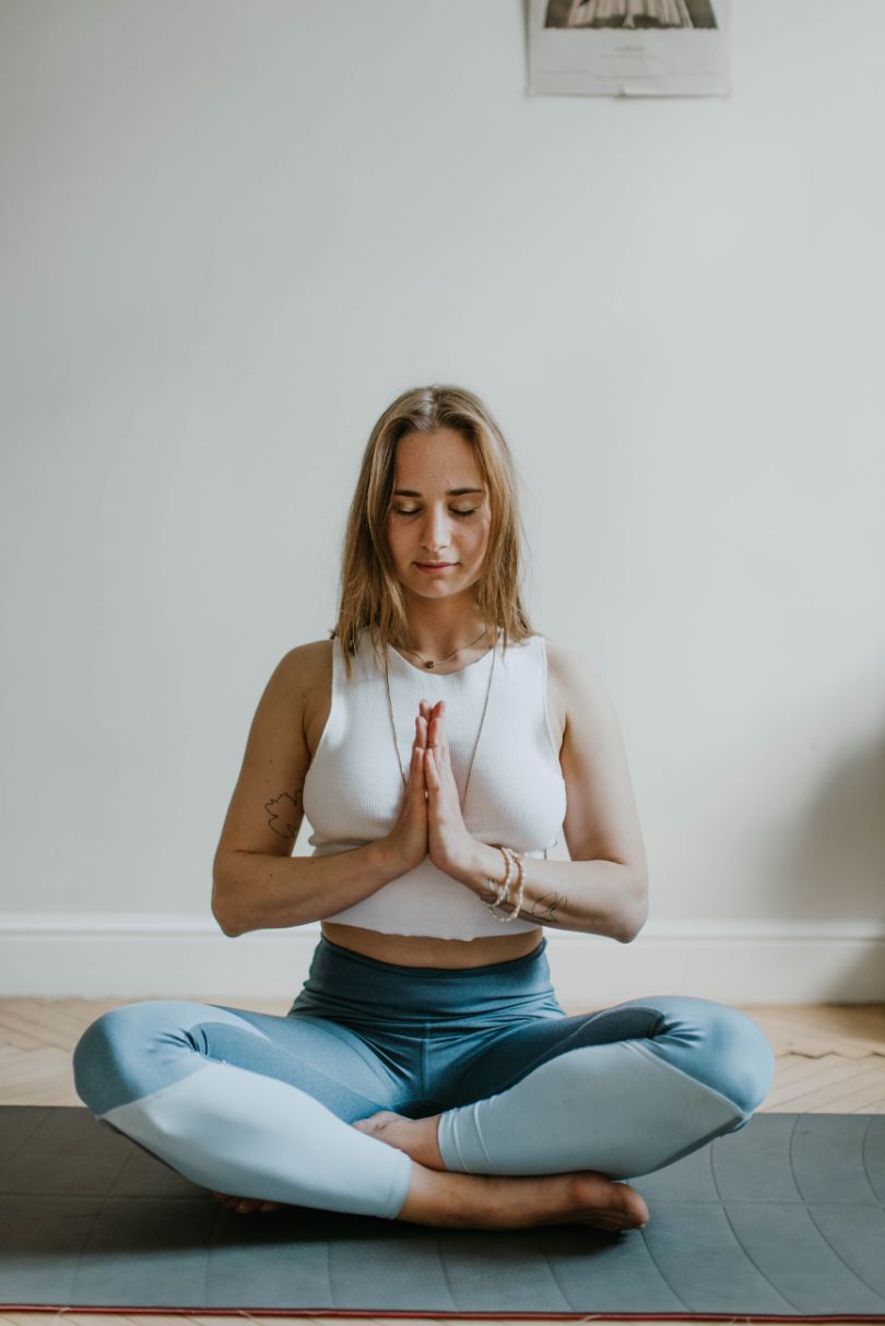 pexels-valeria-ushakova-3094215 woman meditating on yoga mat